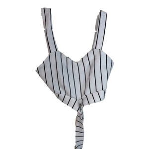 White cropped tank top with black stripes. strap at bottom crosses around waist